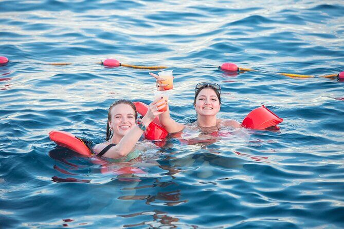 Cabo San Lucas Boat Tour with Snorkeling, Open Bar, and Lunch - The onboard crew energy: service, music, and games